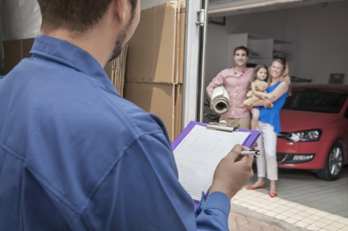 Moving team navigating stairs and access challenges in a Croydon flat